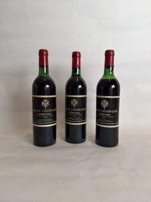 three bottles of wine sitting on top of a white table
