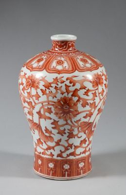 un vase orange et blanc posé sur une table