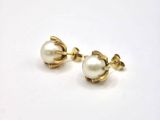 pair of pearl and gold earrings on a white background