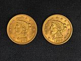 two gold coins, one of which has a head of a woman and one of which has a head of