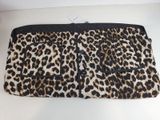 the leopard print purse is on display on a white table