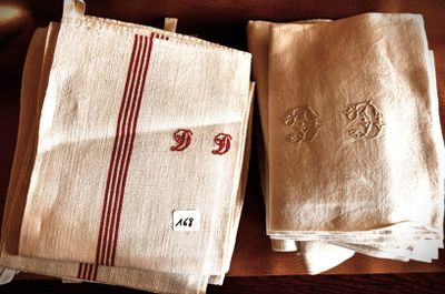 three towels with red and white stripes are on a table
