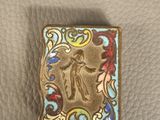 a close up of a metal object on a leather surface