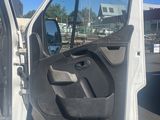 a white truck with its door open in a parking lot