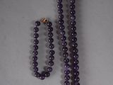 purple beaded necklace and earring set with a gold clasp