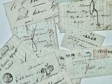 several pieces of old paper with writing on them on a table