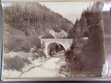 an old photo of a bridge over a river
