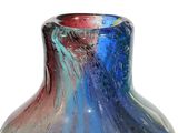 a glass vase with a blue, red, and purple design on it