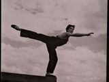 black and white photograph of a man doing a trick on a skateboard
