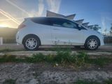 a white car parked in front of a building on a sunny day