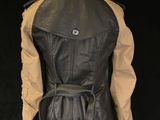 the back view of a black leather jacket on a mannequin mannequin