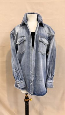 denim shirt on a mannequin stand on a white background