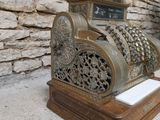 an old fashioned cash register sitting on a table
