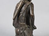 bronze statue of a man with a shield and shield in his hand