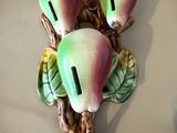 une figurine représentant trois poires sur une branche avec des feuilles