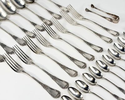 de nombreuses fourchettes et cuillères disposées sur la table