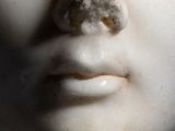 a close up of a statue of a man ' s face