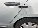 a close up of a car ' s door handle with a sticker on it