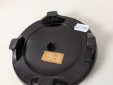 a black object on a white surface with a tag on it
