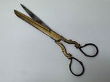a pair of scissors sitting on a white surface