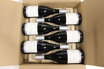 six bottles of wine in a cardboard box on a white surface