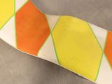 orange, yellow, and white tie on a gray surface