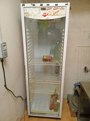a refrigerator that is sitting in the corner of a room