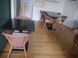 tables and chairs in a room with a refrigerator and a refrigerator