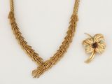 two pieces of jewelry including a necklace, broochle and a broochle