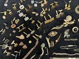 a lot of gold jewelry on a black table
