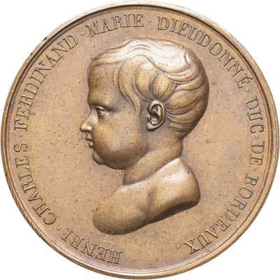 a bronze coin with a portrait of a child on it