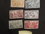 a collection of stamps and a piece of paper on a black background
