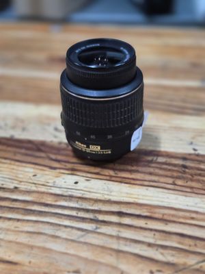 a black camera lens sitting on a wooden table