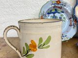 a cup and saucer sitting on a table next to a plate