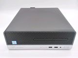 the back of a small computer with a keyboard on top of it