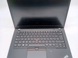the laptop is open on a white surface with a black keyboard