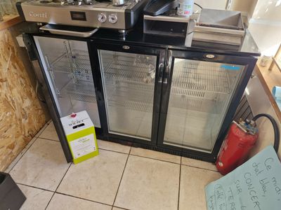 two refrigerators that are sitting in a room
