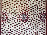 a white and red rug with a floral design on it