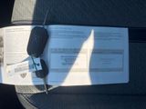 a car key sitting on top of a piece of paper in the back seat of a car