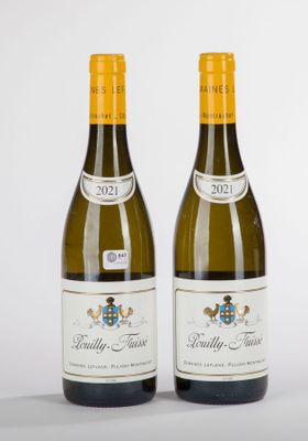 two bottles of wine sitting next to each other on a white surface