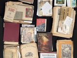 many old books on a table with a black background