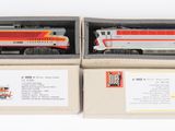 deux boîtes de petits trains posées l'une à côté de l'autre