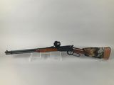 a rifle with a wooden barrel on a white background