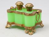 une image représentant une boîte en verre vert ornée de motifs dorés