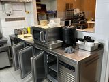 a large kitchen with stainless steel counter tops and appliances