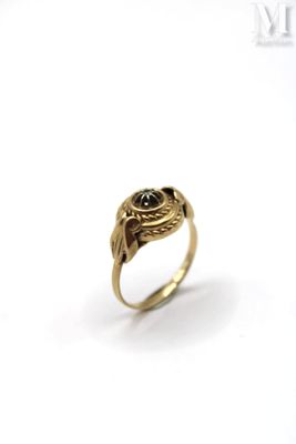 an image of a gold ring with a black stone in the center