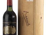 a bottle of wine sitting next to a wooden box
