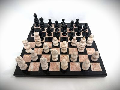 a black and white chess board with chess pieces on it