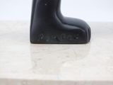 a black cat statue on a marble counter top