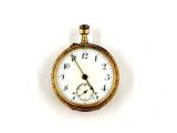 a gold pocket watch with a white face on a white surface